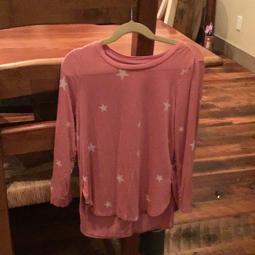 A pink shirt that has white stars. It is  he threw